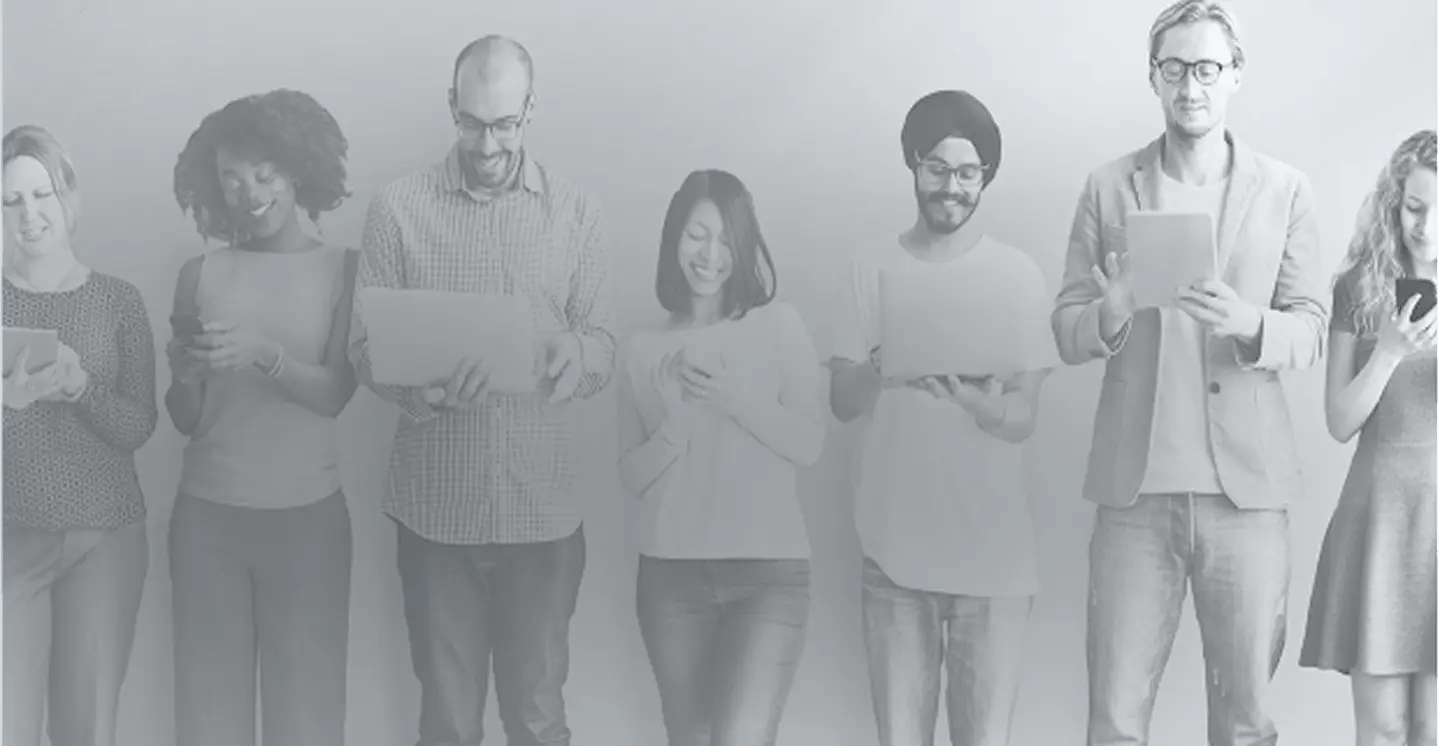 Black and white image of a diverse group of people standing in a row using smart devices, representing digital engagement